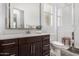 Modern bathroom featuring a marble vanity, large mirror and walk-in shower at 9922 E Thunderbolt Ave, Mesa, AZ 85212