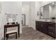 Well-lit bathroom featuring wood floors, double vanity, and a makeup table at 9922 E Thunderbolt Ave, Mesa, AZ 85212