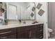 Well-lit bathroom featuring a vanity with dark cabinets, a white countertop, and a large mirror at 9922 E Thunderbolt Ave, Mesa, AZ 85212