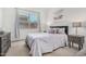 Cozy bedroom with a plush bed, soft lighting, and a view of the backyard at 9922 E Thunderbolt Ave, Mesa, AZ 85212