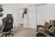 Bedroom featuring a black gaming chair, camouflage sofa, and ample closet space at 9922 E Thunderbolt Ave, Mesa, AZ 85212