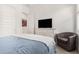 Well-lit bedroom featuring soft carpet, a comfortable bed, and an upholstered chair at 9922 E Thunderbolt Ave, Mesa, AZ 85212