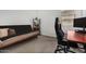 Cozy bedroom featuring neutral tones, a futon, desk, and a display shelf perfect for a home office or relaxation space at 9922 E Thunderbolt Ave, Mesa, AZ 85212