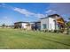 Community lawn and clubhouse area featuring modern buildings and green space for residents to enjoy at 9922 E Thunderbolt Ave, Mesa, AZ 85212