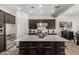 Modern kitchen boasts a large center island with seating and dark wood cabinetry at 9922 E Thunderbolt Ave, Mesa, AZ 85212