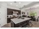 Spacious kitchen featuring a large island, stainless steel appliances, and dark wood cabinets at 9922 E Thunderbolt Ave, Mesa, AZ 85212