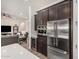 Beautiful kitchen with stainless steel appliances, built-in wine cooler, and dark cabinetry at 9922 E Thunderbolt Ave, Mesa, AZ 85212