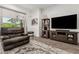 Relaxing living room with dark leather recliner and backyard view at 9922 E Thunderbolt Ave, Mesa, AZ 85212