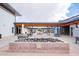 Charming patio with a central stone feature and comfortable seating areas for relaxing and socializing with neighbors at 9922 E Thunderbolt Ave, Mesa, AZ 85212