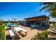 Outdoor patio and bar area with ample seating and a well-equipped outdoor kitchen, perfect for entertaining guests at 9922 E Thunderbolt Ave, Mesa, AZ 85212