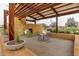 Outdoor patio area featuring seating and a fireplace, perfect for relaxing or entertaining guests at 9922 E Thunderbolt Ave, Mesa, AZ 85212