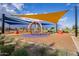 Community playground with shade structures, play equipment and wood chip ground covering at 9922 E Thunderbolt Ave, Mesa, AZ 85212