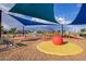 Community playground with shade structures, play equipment and colorful ground covering at 9922 E Thunderbolt Ave, Mesa, AZ 85212