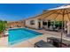 Backyard featuring a sparkling pool, patio, and lounging area, ideal for relaxation and outdoor enjoyment at 9922 E Thunderbolt Ave, Mesa, AZ 85212