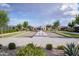 Community bocce ball court with a paved walkway, landscaping, and homes, providing a great outdoor recreation activity at 9922 E Thunderbolt Ave, Mesa, AZ 85212