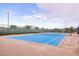 Outdoor tennis court with a blue playing surface and a brown perimeter for recreation at 9922 E Thunderbolt Ave, Mesa, AZ 85212