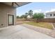 Covered patio and spacious backyard with lush lawn and trees at 1015 E Penny Ln, San Tan Valley, AZ 85140