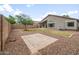 Spacious backyard with a low-maintenance rock landscaping, small lawn, and desert trees at 1015 E Penny Ln, San Tan Valley, AZ 85140