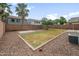 Large backyard featuring gravel landscaping, mature trees, and a grassy area at 1015 E Penny Ln, San Tan Valley, AZ 85140