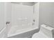 Clean bathroom with a white tiled shower and tub combination and a modern low-flow toilet at 1015 E Penny Ln, San Tan Valley, AZ 85140