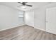 Cozy bedroom with gray walls, wood-look flooring, a ceiling fan, and a sliding door closet at 1015 E Penny Ln, San Tan Valley, AZ 85140
