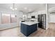 Modern kitchen featuring white cabinets, stainless steel appliances, and an island at 1015 E Penny Ln, San Tan Valley, AZ 85140