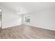 Bright, airy living room with hardwood flooring, neutral paint, modern chandelier, and natural light at 1015 E Penny Ln, San Tan Valley, AZ 85140