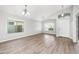Open-concept living area showcasing hardwood floors, a vaulted ceiling, and a bright and airy feel at 1015 E Penny Ln, San Tan Valley, AZ 85140