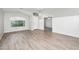 Spacious living room with wood-look flooring, neutral colors, and abundant natural light at 1015 E Penny Ln, San Tan Valley, AZ 85140