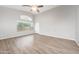 Bright living room with vaulted ceiling, gray walls, picture window, and gray wood-look floors at 1015 E Penny Ln, San Tan Valley, AZ 85140