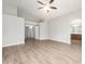 Spacious living room with gray wood-look flooring, gray walls, and an archway leading to the bathroom at 1015 E Penny Ln, San Tan Valley, AZ 85140