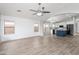 Open floor plan showcases a stylish kitchen island, modern appliances, and gray wood floors at 1015 E Penny Ln, San Tan Valley, AZ 85140