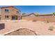 Oversized backyard with gravel landscaping, block wall fencing, covered patio, and desert plants at 10745 W Taft St, Phoenix, AZ 85037