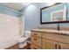 Bathroom featuring blue walls, vanity with granite countertop, and bathtub shower at 10745 W Taft St, Phoenix, AZ 85037