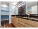 Bathroom featuring a double sink vanity with wood cabinets and granite countertop at 10745 W Taft St, Phoenix, AZ 85037