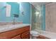 Bathroom featuring blue walls, shower with glass door, and sink offering style and functionality at 10745 W Taft St, Phoenix, AZ 85037
