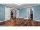 Light blue bedroom with wood floor, recessed lighting, crown molding and white doors at 10745 W Taft St, Phoenix, AZ 85037