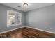 Bedroom featuring wood floor, baseboards, recessed lighting, gray walls and plantation shutters at 10745 W Taft St, Phoenix, AZ 85037