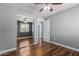 Bedroom boasts mirrored closet doors, ceiling fan, painted walls, and wood floors, adding comfort at 10745 W Taft St, Phoenix, AZ 85037