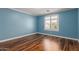 Light blue bedroom featuring wood floor, recessed lighting, crown molding and plantation shutters at 10745 W Taft St, Phoenix, AZ 85037