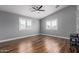 Spacious bedroom with ceiling fan, recessed lighting, wood floor and plantation shutters at 10745 W Taft St, Phoenix, AZ 85037