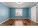 Light blue bedroom featuring wood floor, recessed lighting, crown molding and plantation shutters at 10745 W Taft St, Phoenix, AZ 85037