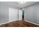 Bright bedroom features wood floors, painted walls, and closet space, adding comfort and functionality at 10745 W Taft St, Phoenix, AZ 85037