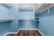 Walk-in closet with shelves, wood floor, recessed lighting and blue walls at 10745 W Taft St, Phoenix, AZ 85037