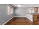 Dining area featuring wood floors, neutral walls, and views into the kitchen at 10745 W Taft St, Phoenix, AZ 85037