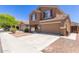 Charming two-story home features a two-car garage and well-maintained front yard with stone pathway at 10745 W Taft St, Phoenix, AZ 85037