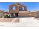 Charming two-story home features a two-car garage and well-maintained front yard with stone pathway at 10745 W Taft St, Phoenix, AZ 85037