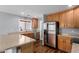 Bright kitchen with stainless steel appliances, ample cabinet space, and a breakfast bar at 10745 W Taft St, Phoenix, AZ 85037