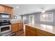 Bright kitchen with wood cabinets, countertop, stainless steel appliances and wood floors at 10745 W Taft St, Phoenix, AZ 85037