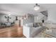 Bright, open-concept living room featuring hardwood floors and seamless transition to the dining and kitchen areas at 10745 W Taft St, Phoenix, AZ 85037